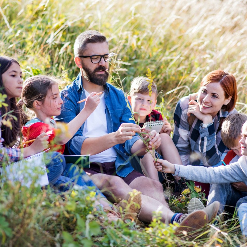group-of-school-children-with-teacher-on-field-trip-in-nature.jpg